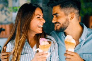 A happy couple enjoying a romantic date, sharing smiles while savoring delicious ice cream—a perfect moment reminiscent of the joy you can rediscover as you strive to get your ex back